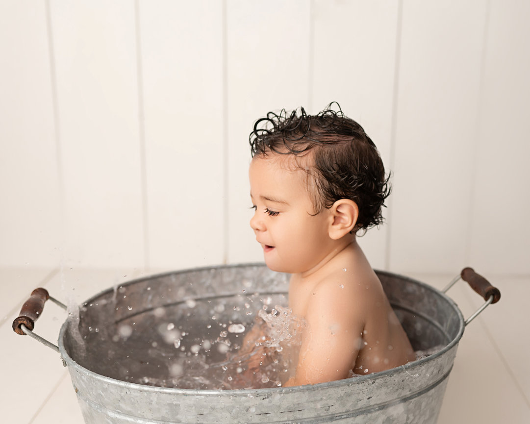 Pure and playful moment captured in Middletown, NJ, of baby splashing water joyfully