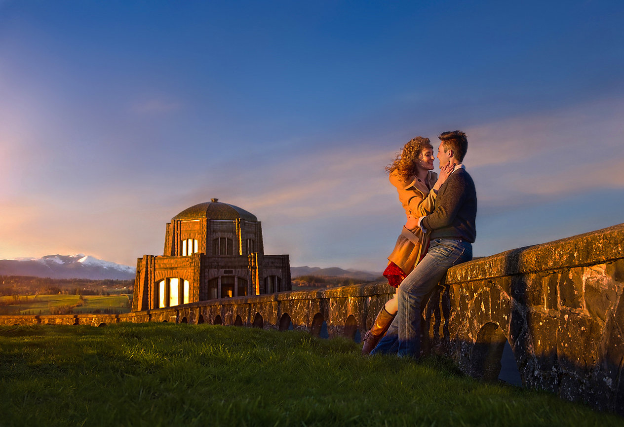Couple embracing near a stone ruin at sunset.