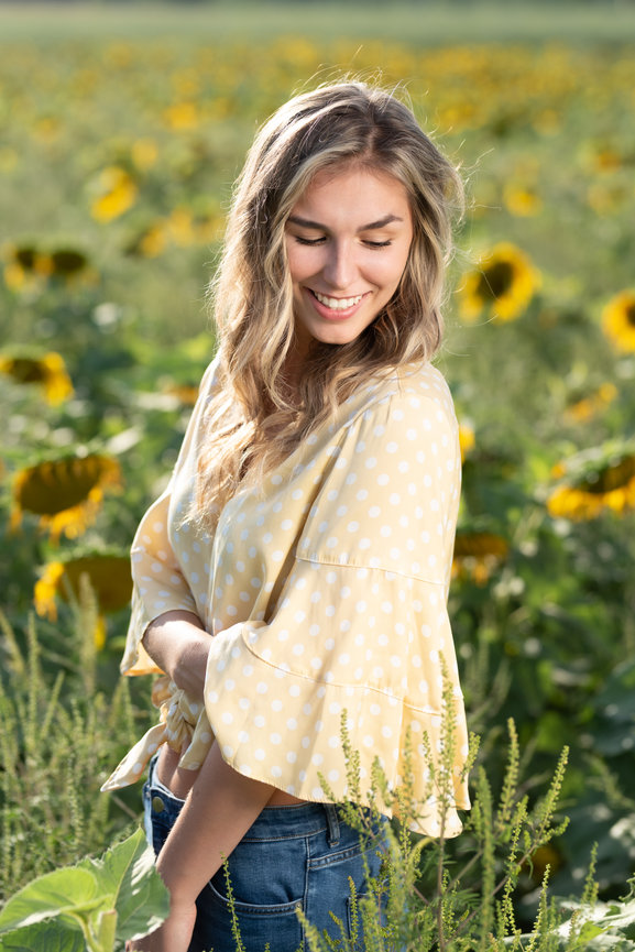 female senior portraits high school sunflowers