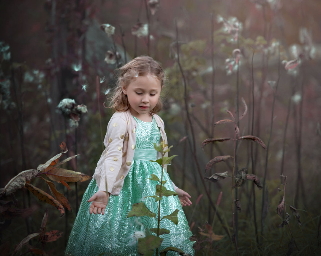 Young girl in teal dress walking through dreamy outdoor field during fine art portrait session in Hudson Valley NY
