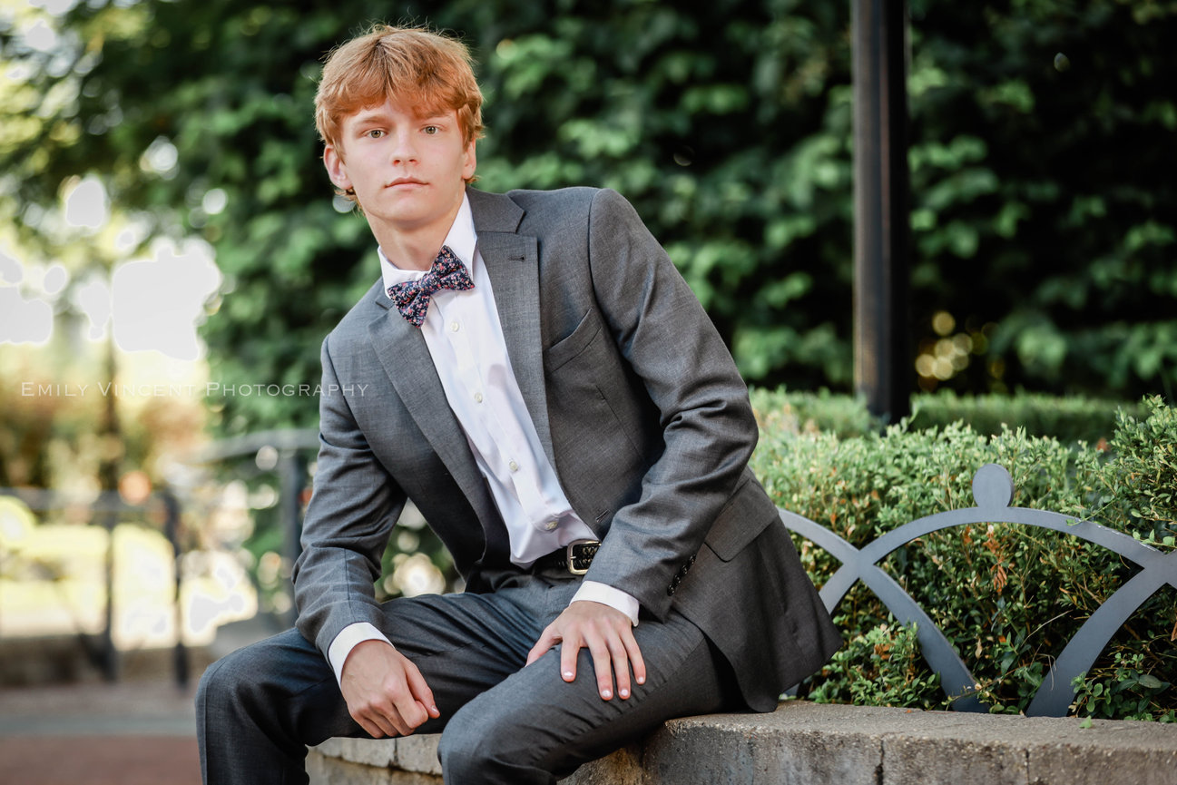 High school senior wearing suit in outdoor photo