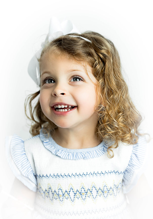 Child posing for fine art heirloom portrait in studio setting”