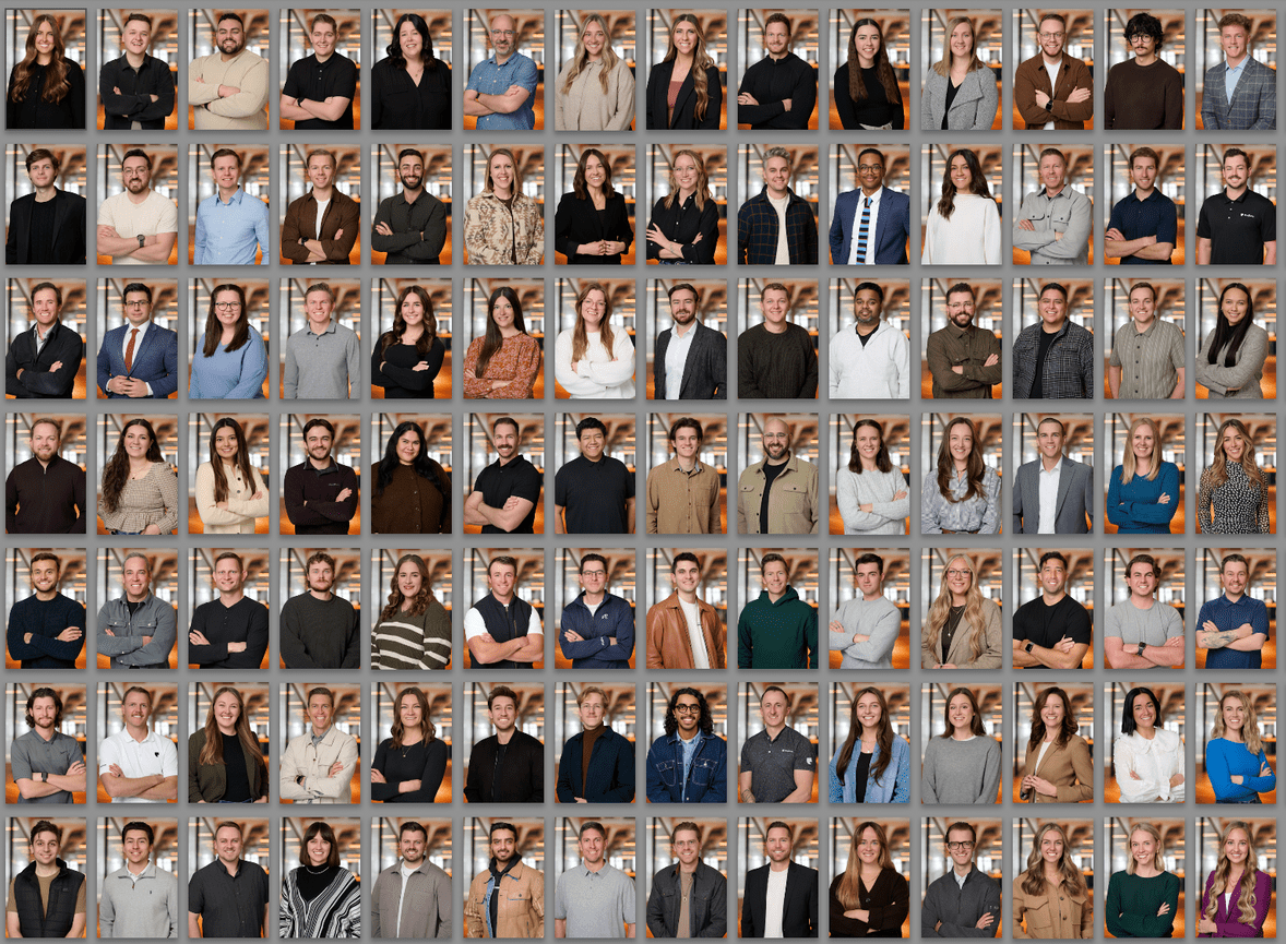 Grid of diverse people posing with arms crossed. Each person smiles, wearing various casual and formal outfits, against a shelf backdrop.