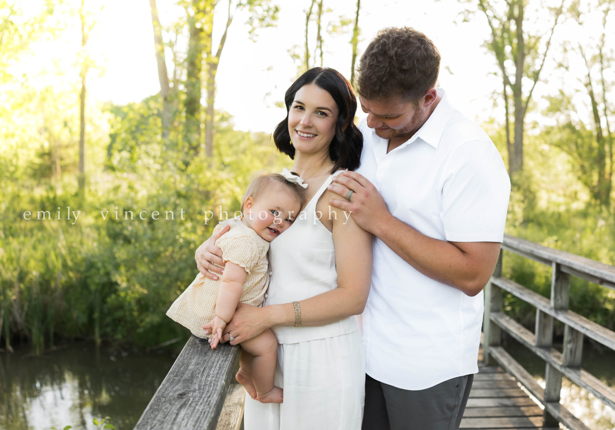 Parents sitting with child in grassy field