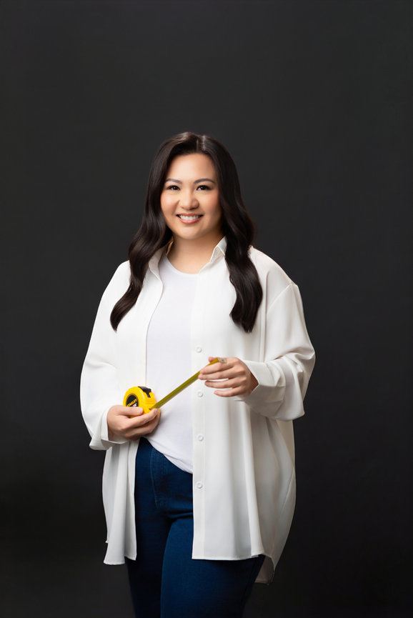 Portrait of a female designer holding measuring tape