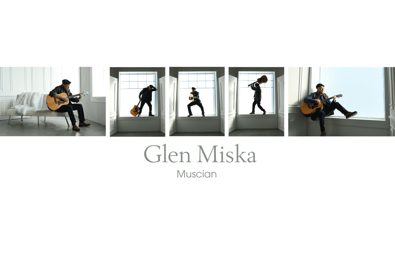 Musician, Glen Miska, playing his guitar in the window sill of the Kliks Photography studio in Cedar Rapids, Iowa.