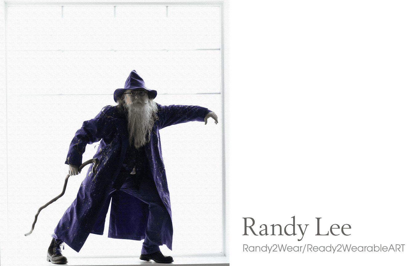 A man in a purple coat and wizard hat strikes an artful pose in a window sill during a fashion session at Kliks Photography in Cedar Rapids, Iowa