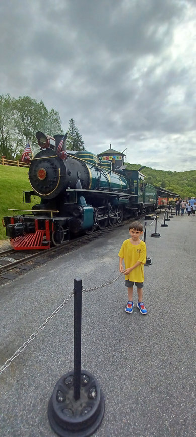 Child in front of a vintage train